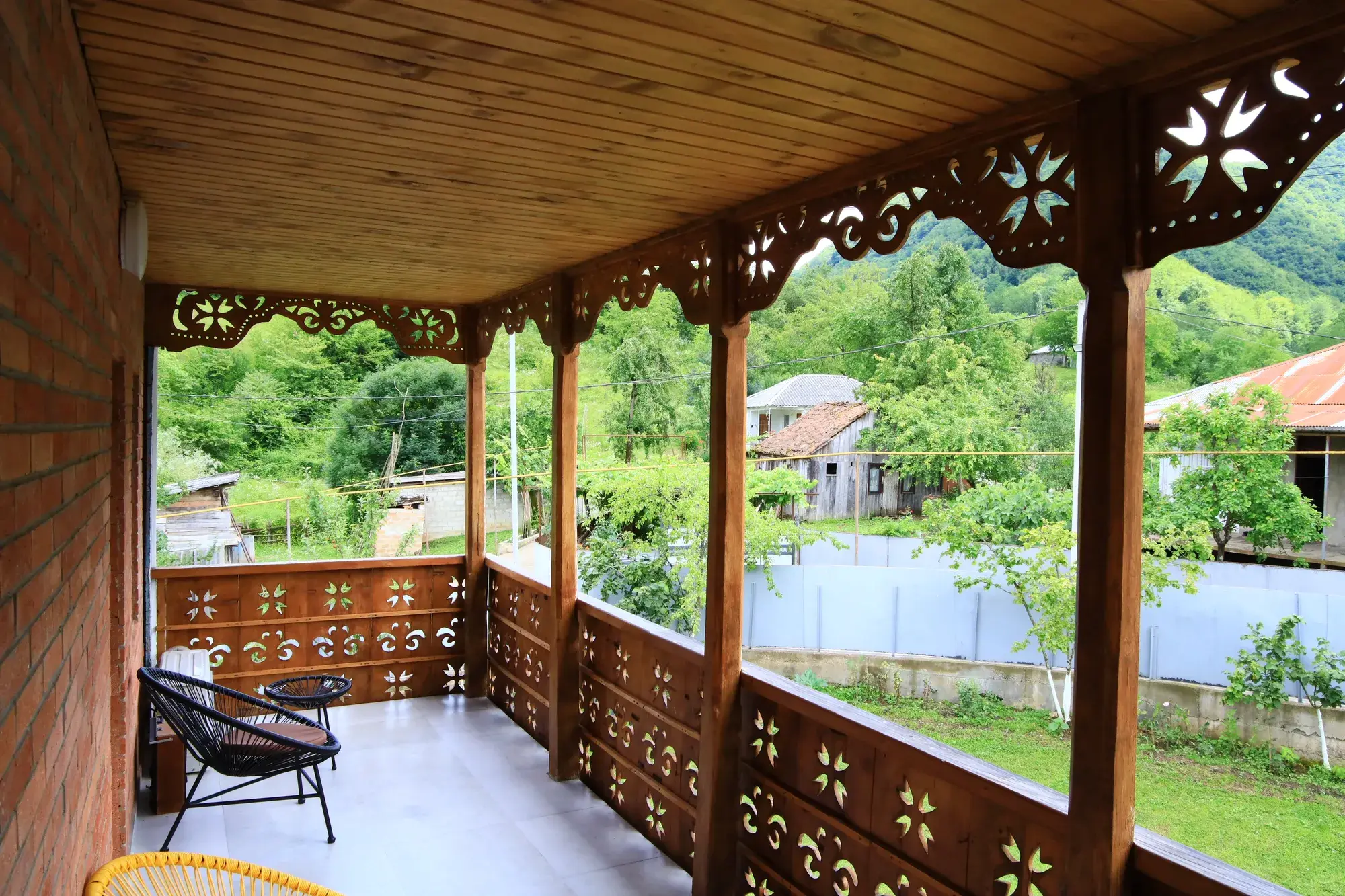 Villa Tabakini — carved wooden veranda with a view